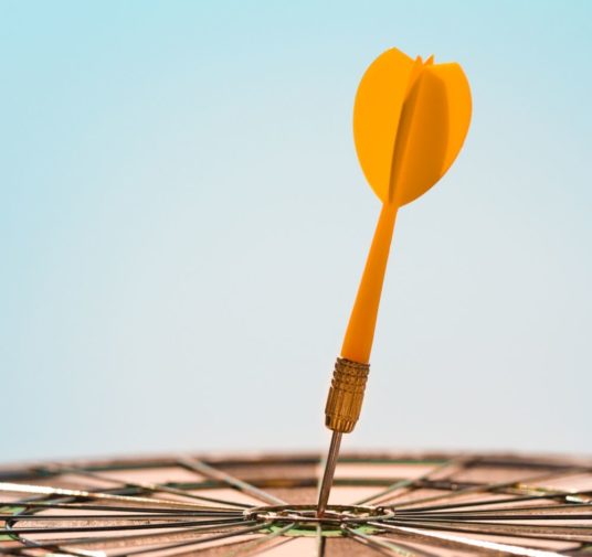 A Yellow Color Dart on a Dart Board